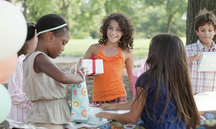 girl-at-birthday-party-with-birthday-present-2024-05-28-22-03-19-utc-min